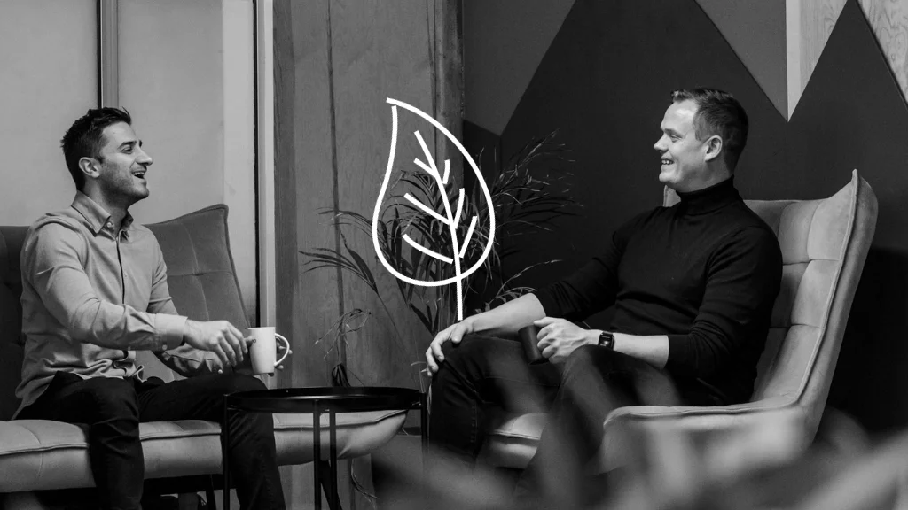 Two colleagues enjoying coffee and a laugh